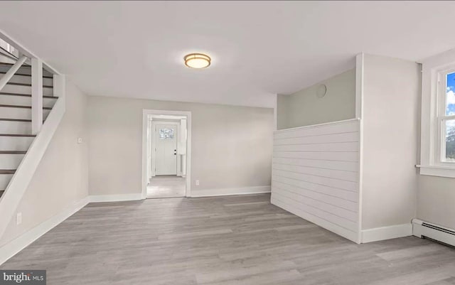 1832 E Buckshutem Rd, Millville, NJ 08332 - empty room featuring wood finished floors, stairway, and baseboard heating