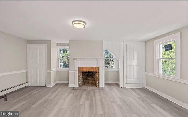 1832 E Buckshutem Rd, Millville, NJ 08332 - unfurnished living room with light wood-style flooring, a baseboard radiator, and a fireplace with flush hearth