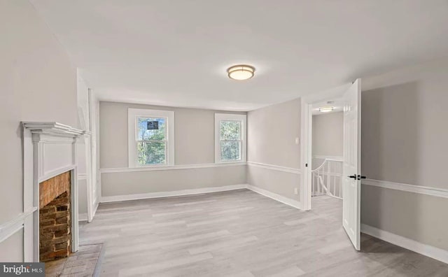 1832 E Buckshutem Rd, Millville, NJ 08332 - spare room featuring light wood-style flooring and a fireplace