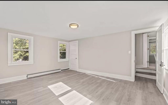 1832 E Buckshutem Rd, Millville, NJ 08332 - unfurnished room with a baseboard heating unit, wood finished floors, and plenty of natural light