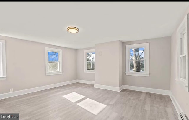 1832 E Buckshutem Rd, Millville, NJ 08332 - empty room with a baseboard heating unit and light wood-type flooring