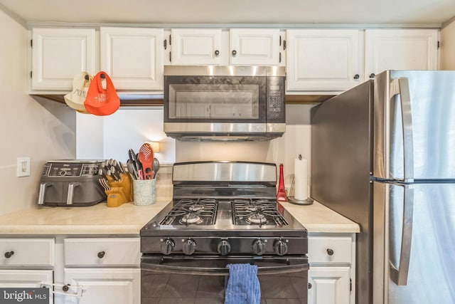 9001 Ridge Ave Unit 31, Philadelphia, PA 19128 - kitchen with stainless steel appliances, light countertops, and white cabinetry