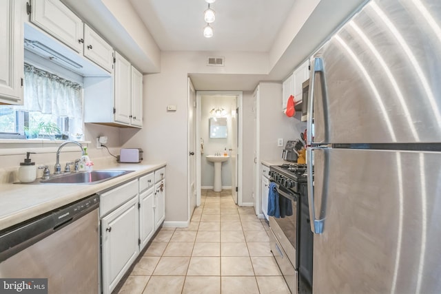 9001 Ridge Ave Unit 31, Philadelphia, PA 19128 - kitchen with appliances with stainless steel finishes, white cabinets, and light countertops