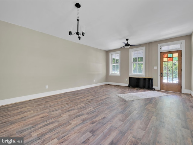 221 Orchard St, Auburn, PA 17922 - unfurnished living room with radiator, wood finished floors, and a ceiling fan