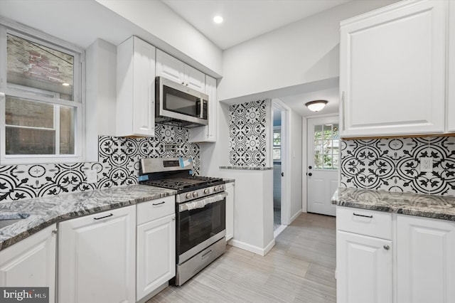 1408 N Redfield St, Philadelphia, PA 19151 - kitchen featuring stainless steel appliances, decorative backsplash, light stone countertops, white cabinets, and recessed lighting
