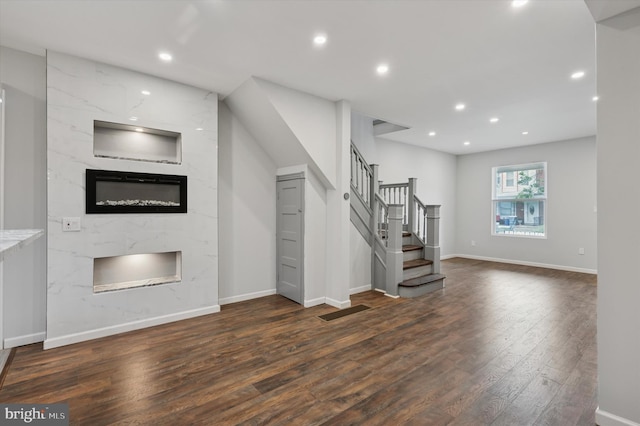 1408 N Redfield St, Philadelphia, PA 19151 - unfurnished living room featuring a high end fireplace, wood finished floors, stairway, and recessed lighting