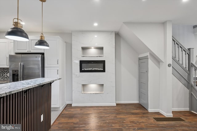 1408 N Redfield St, Philadelphia, PA 19151 - kitchen with stainless steel fridge, dark wood finished floors, a fireplace, white cabinetry, and recessed lighting