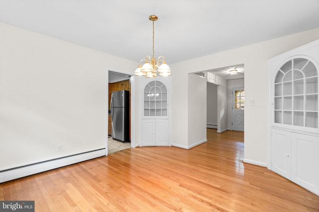 10833 Hunting Ln, Columbia, MD 21044 - spare room with a chandelier, baseboard heating, and light wood-style flooring