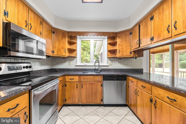10833 Hunting Ln, Columbia, MD 21044 - kitchen featuring stainless steel appliances, open shelves, brown cabinets, and tasteful backsplash