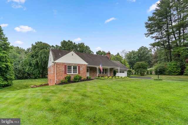10833 Hunting Ln, Columbia, MD 21044 - ranch-style house with brick siding, an attached garage, a front lawn, and a chimney