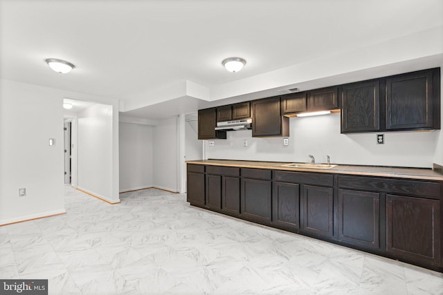 10833 Hunting Ln, Columbia, MD 21044 - kitchen with dark brown cabinetry, under cabinet range hood, and light countertops