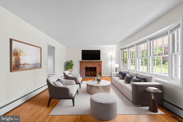 10833 Hunting Ln, Columbia, MD 21044 - living room featuring a baseboard radiator, wood finished floors, and a fireplace