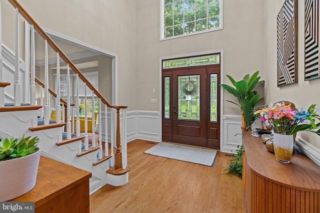 14 Leapson Ln, Doylestown, PA 18901 - entrance foyer featuring stairway, wood finished floors, wainscoting, a towering ceiling, and a decorative wall