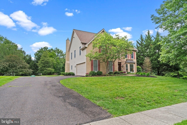14 Leapson Ln, Doylestown, PA 18901 - view of front facade with driveway, an attached garage, a front lawn, and a chimney