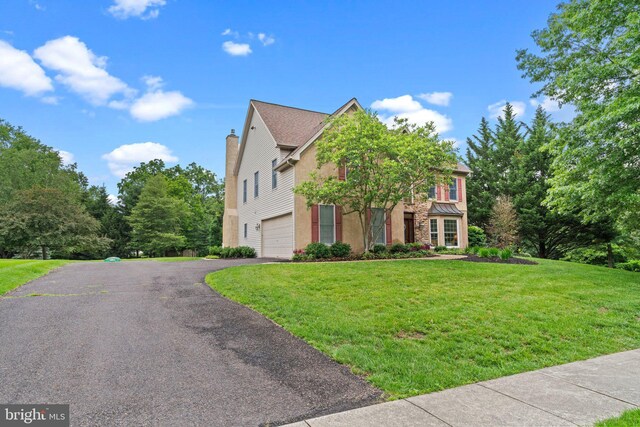 14 Leapson Ln, Doylestown, PA 18901 - view of front facade with driveway, an attached garage, a front lawn, and a chimney