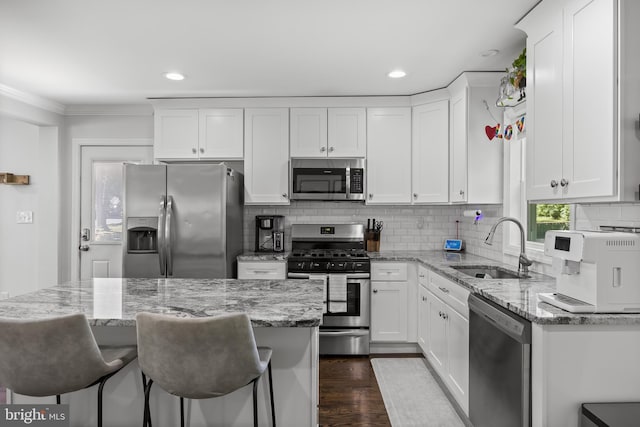 100 Carolina Ave, Cherry Hill, NJ 08003 - kitchen with stainless steel appliances, white cabinets, decorative backsplash, a breakfast bar area, and dark wood-style floors