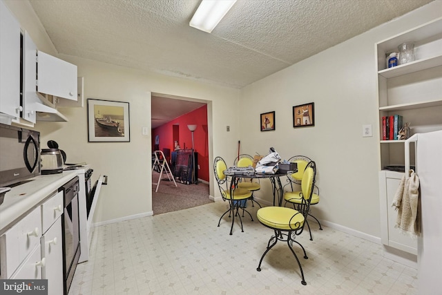400 Glendale Rd Unit E 13, Havertown, PA 19083 - kitchen with white cabinets, a textured ceiling, light countertops, and black microwave