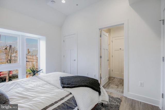 4901 1st St NW Unit 5, Washington, DC 20011 - bedroom featuring vaulted ceiling and wood finished floors