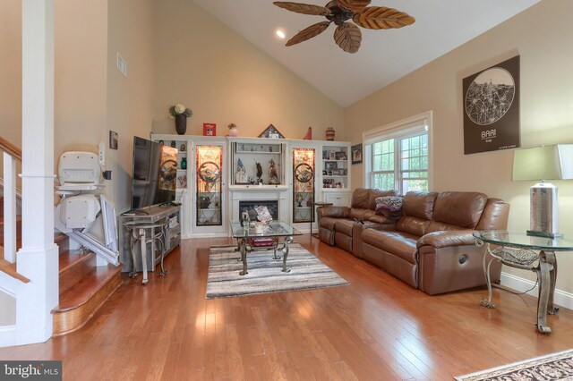 162 High Pointe Dr, Hummelstown, PA 17036 - living room with high vaulted ceiling, ceiling fan, wood finished floors, a fireplace, and stairway
