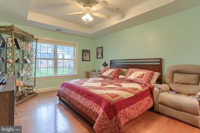 162 High Pointe Dr, Hummelstown, PA 17036 - bedroom with a raised ceiling, wood finished floors, and ceiling fan
