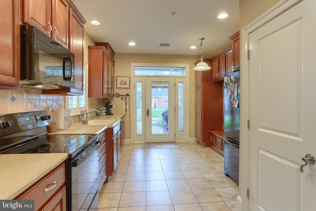 162 High Pointe Dr, Hummelstown, PA 17036 - kitchen with black appliances, backsplash, recessed lighting, light countertops, and brown cabinetry