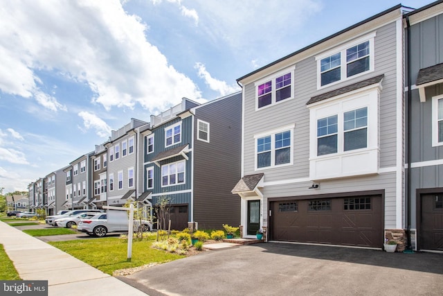 18351 Moss Garden Rd, Dumfries, VA 22026 - multi unit property with a residential view, an attached garage, asphalt driveway, and stone siding