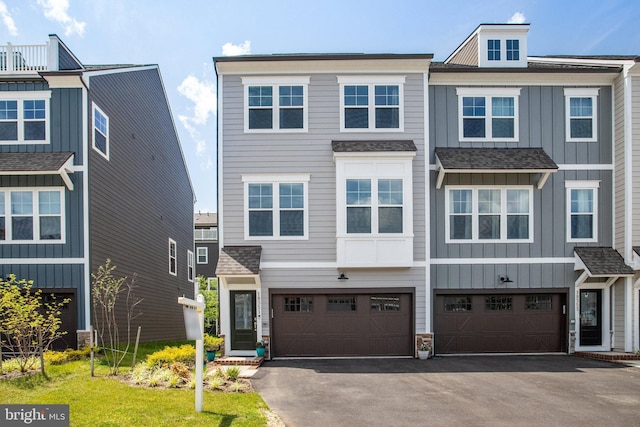18351 Moss Garden Rd, Dumfries, VA 22026 - townhome / multi-family property featuring board and batten siding, asphalt driveway, an attached garage, and stone siding