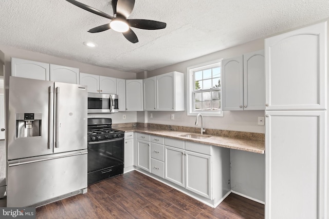 16 Richardson Ave, Linwood, PA 19061 - kitchen featuring stainless steel appliances, a textured ceiling, a ceiling fan, dark wood-style floors, and white cabinetry