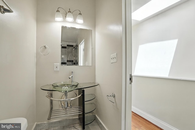 437 Pitman Pl, Baltimore, MD 21202 - bathroom featuring a sink and a skylight