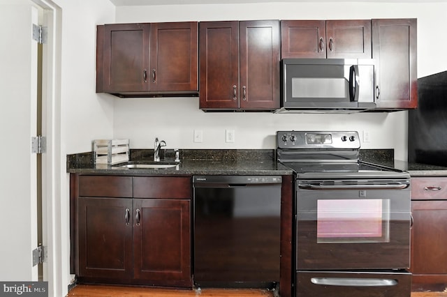 437 Pitman Pl, Baltimore, MD 21202 - kitchen featuring black appliances, dark stone counters, and dark brown cabinetry