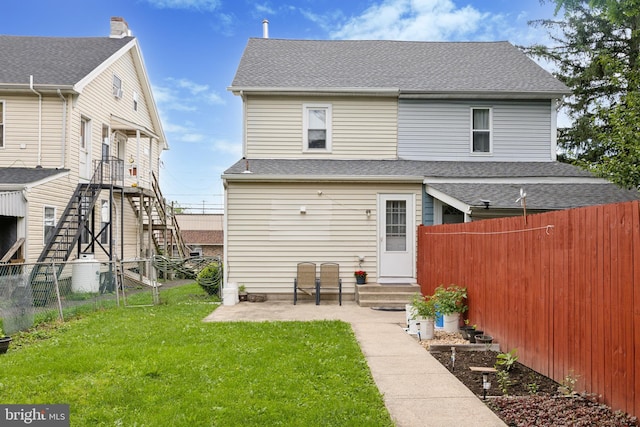 909 Walnut St, Lansdale, PA 19446 - back of property featuring a fenced backyard, stairway, a patio area, entry steps, and a shingled roof