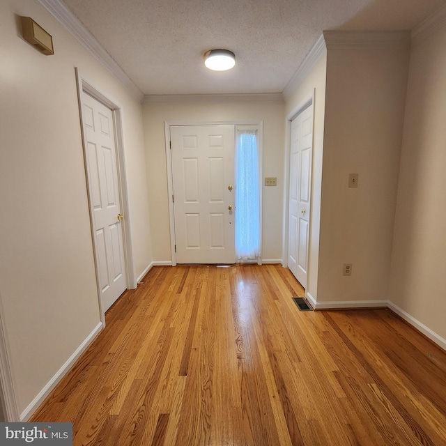 184 Steven Ln, Wilmington, DE 19808 - foyer with light wood-style flooring, ornamental molding, and a textured ceiling