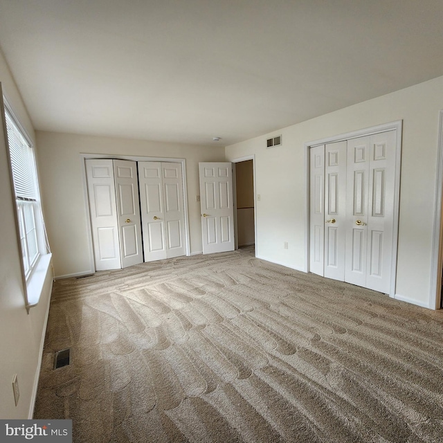 184 Steven Ln, Wilmington, DE 19808 - unfurnished bedroom featuring multiple closets, carpet floors, and multiple windows