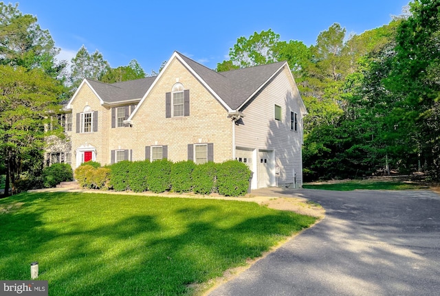 23273 Nicholson St, Hollywood, MD 20636 - view of front of property featuring a garage, asphalt driveway, a front yard, and brick siding