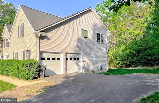 23273 Nicholson St, Hollywood, MD 20636 - view of home's exterior featuring a garage and asphalt driveway