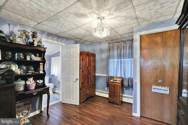 325 Summit Ave, Reading, PA 19607 - dining room featuring a baseboard heating unit, wood finished floors, and a chandelier