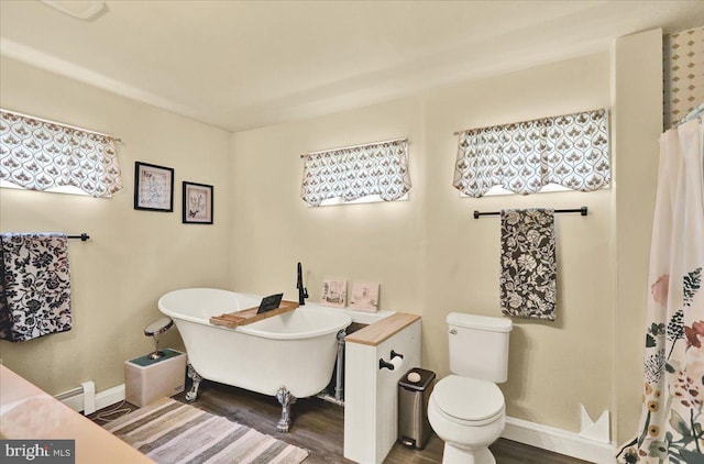 325 Summit Ave, Reading, PA 19607 - bathroom with wood finished floors, a soaking tub, a baseboard heating unit, and a shower with curtain