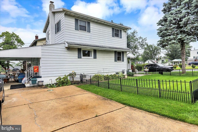 325 Summit Ave, Reading, PA 19607 - back of property featuring a chimney, a patio area, and a carport