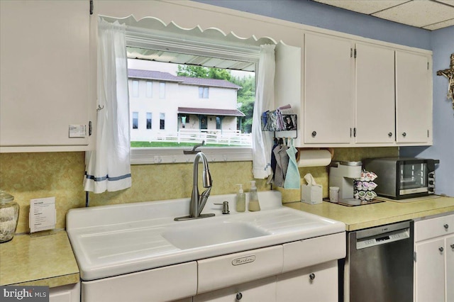 325 Summit Ave, Reading, PA 19607 - kitchen featuring dishwasher, light countertops, and white cabinetry
