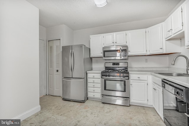 3701 S George Mason Dr Unit 611N, Falls Church, VA 22041 - kitchen featuring stainless steel appliances, white cabinets, light countertops, and a textured ceiling