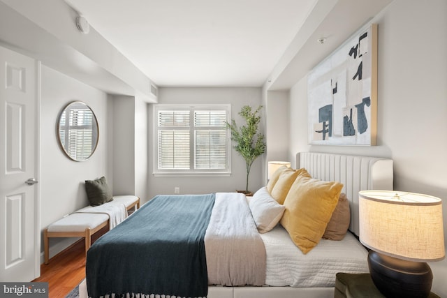 3401 38th St NW Unit 411, Washington, DC 20016 - bedroom with radiator heating unit and wood finished floors