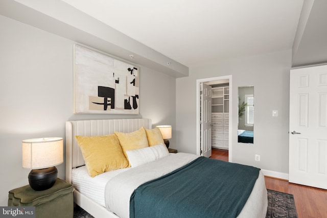 3401 38th St NW Unit 411, Washington, DC 20016 - bedroom featuring wood finished floors, a spacious closet, and a closet