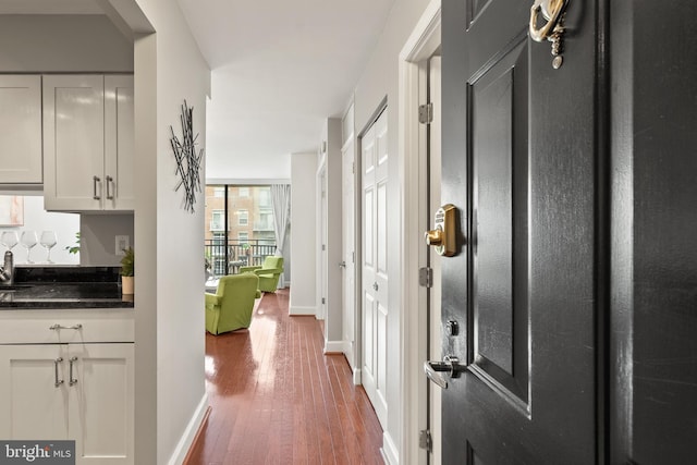 3401 38th St NW Unit 411, Washington, DC 20016 - hallway featuring hardwood / wood-style floors and arched walkways