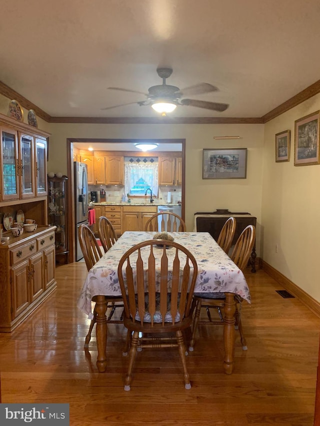 554 Locust St, Bristol, PA 19007 - dining room featuring crown molding, ceiling fan, and light wood-style flooring