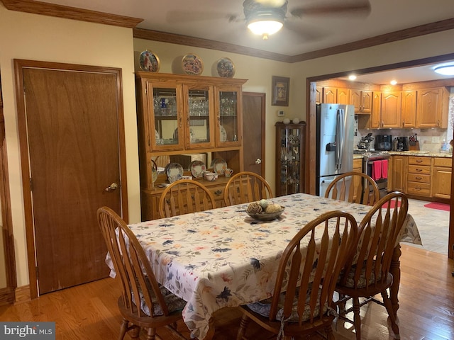 554 Locust St, Bristol, PA 19007 - dining room featuring a ceiling fan, light wood finished floors, and ornamental molding