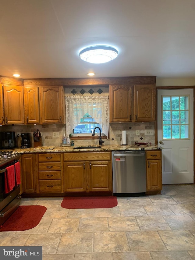 554 Locust St, Bristol, PA 19007 - kitchen with appliances with stainless steel finishes, backsplash, light stone countertops, and light stone finish flooring