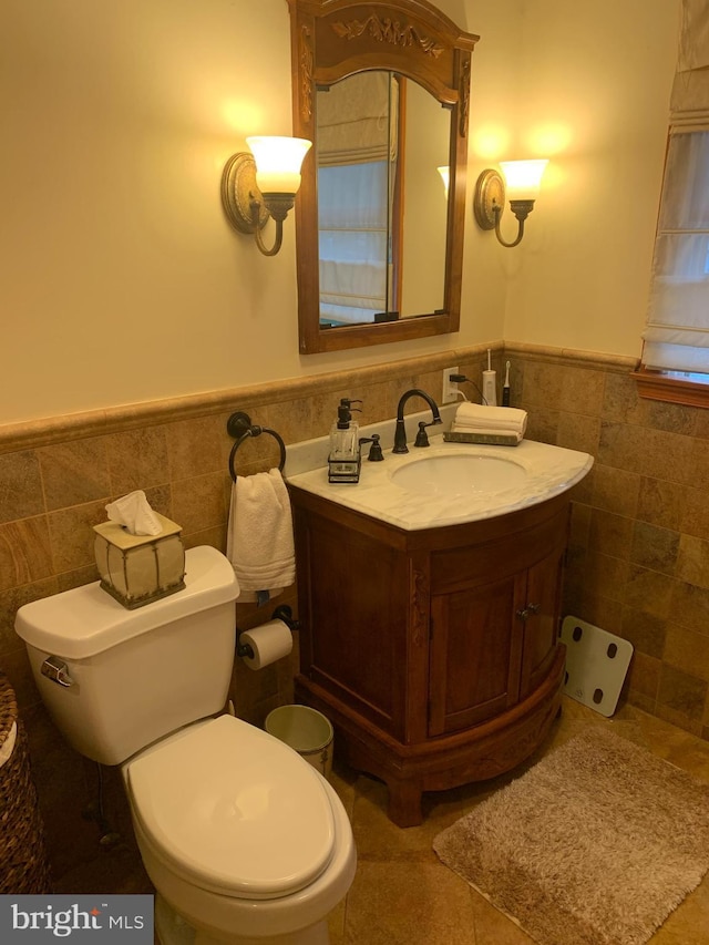 554 Locust St, Bristol, PA 19007 - half bath featuring tile walls, wainscoting, and vanity