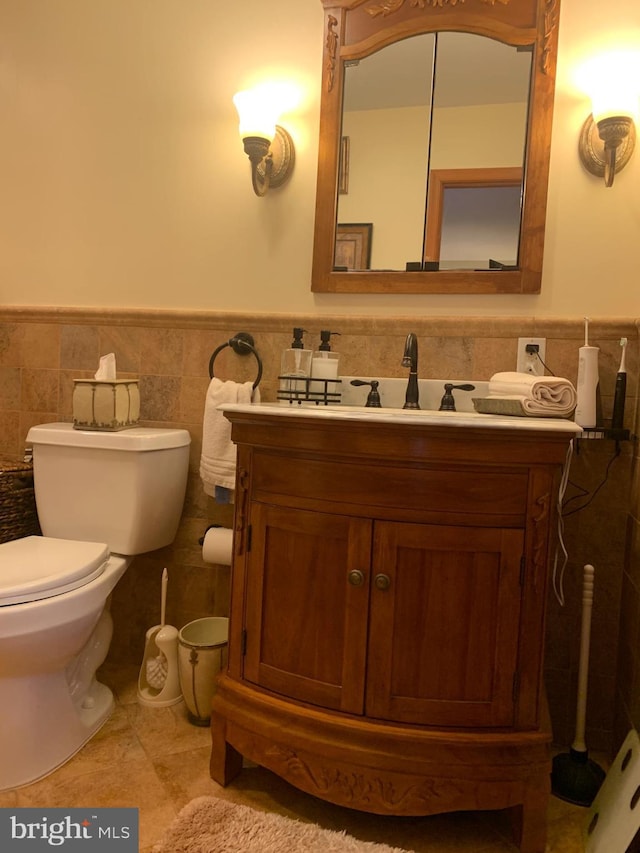 554 Locust St, Bristol, PA 19007 - bathroom with wainscoting, vanity, tile walls, and tile patterned floors