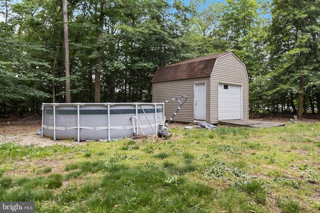 10560 S Faulkner Rd, Faulkner, MD 20632 - view of yard with a garage, an outdoor pool, an outbuilding, and view of wooded area