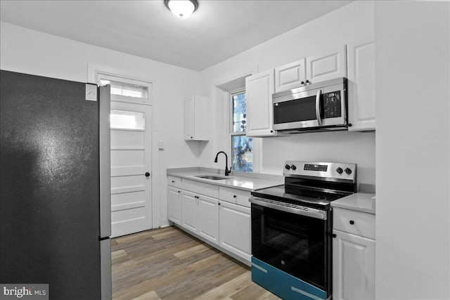18 Belview Ave, Hagerstown, MD 21742 - kitchen featuring stainless steel appliances, light countertops, white cabinets, and light wood-style flooring